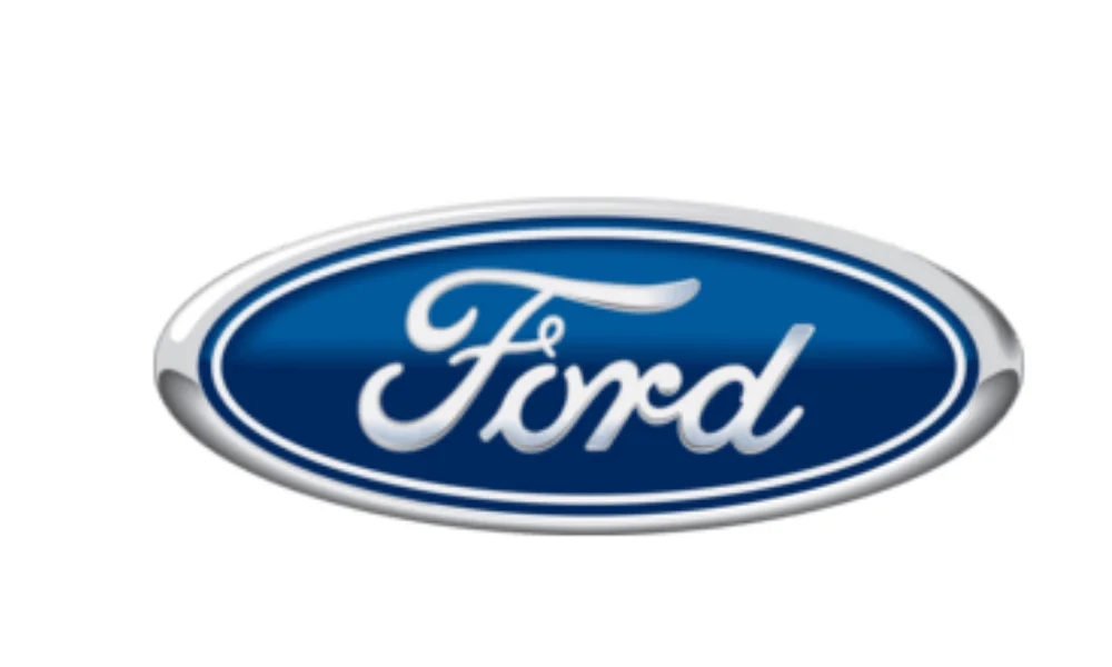 Ford car logo displayed as a white cursive “Ford” wordmark centered inside a dark blue oval emblem with a silver metallic border, shown against a plain white background. The image represents the Ford vehicle brand.