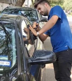 Emergency locksmith safely unlocking car door with professional tools during lockout